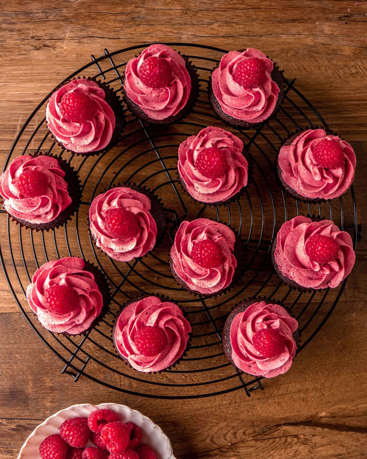 cupcakes with raspberry buttercream piped on top