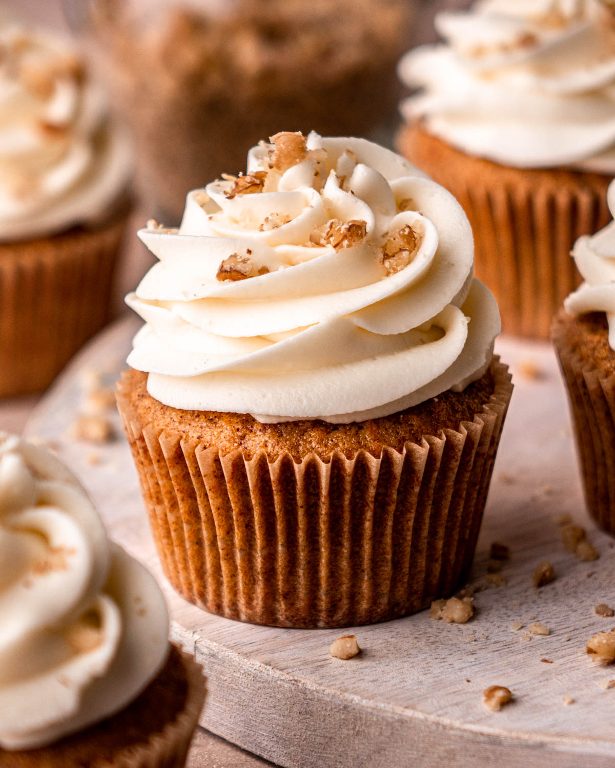 close up of one carrot cake cupcake with cream cheese frosting 