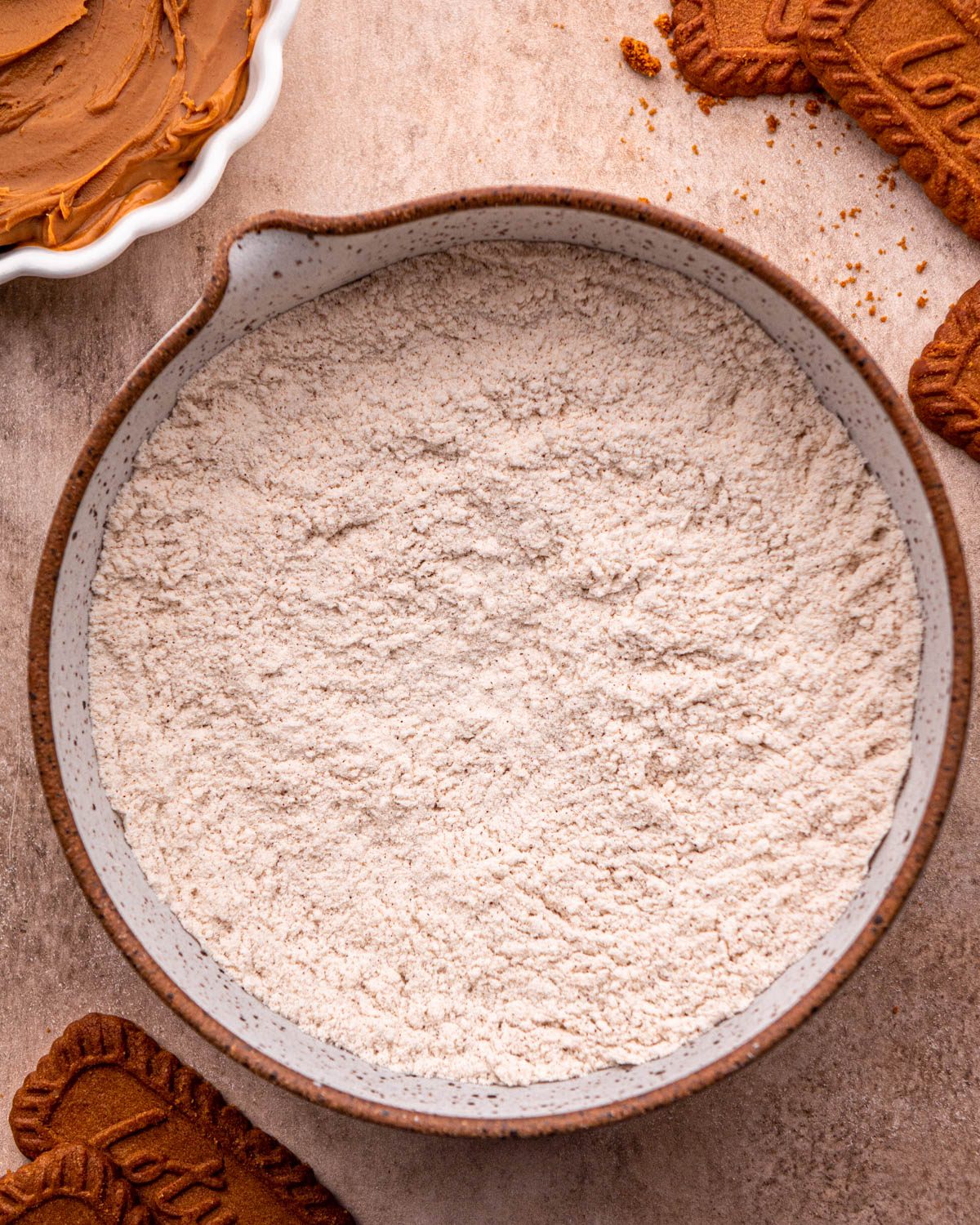 small bowl with flour, cinnamon, baking soda, baking powder and salt whisked together