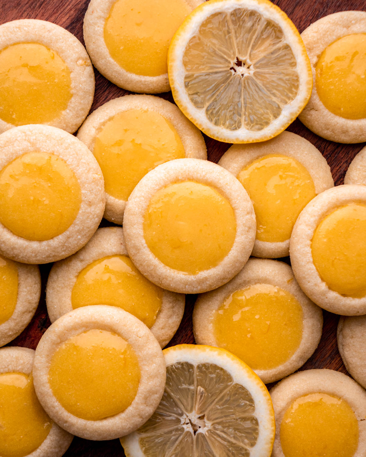 lemon curd cookies grouped together with lemon slices 