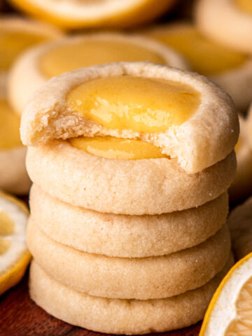stack of lemon curd cookies, top cookie with bite taken out