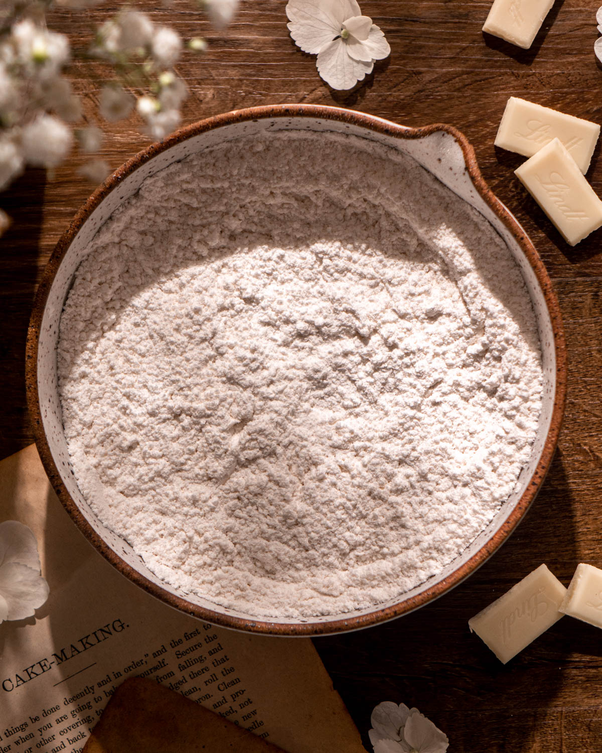 flour, baking powder, baking soda and salt whisked together in a ceramic bowl