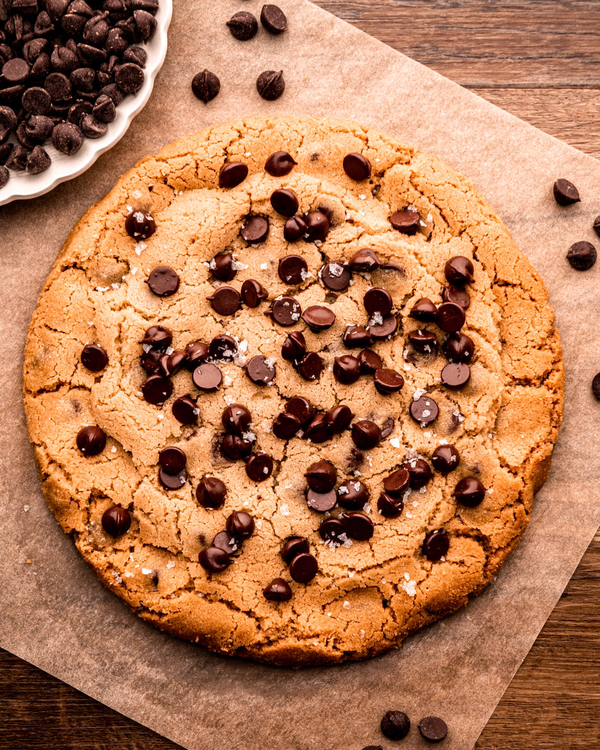 giant chocolate chip cookie on parchment paper