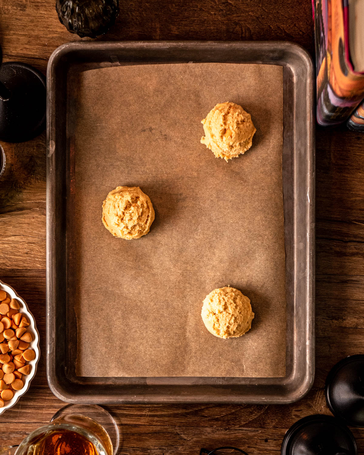 dough scooped into balls on a parchment paper lined baking sheet
