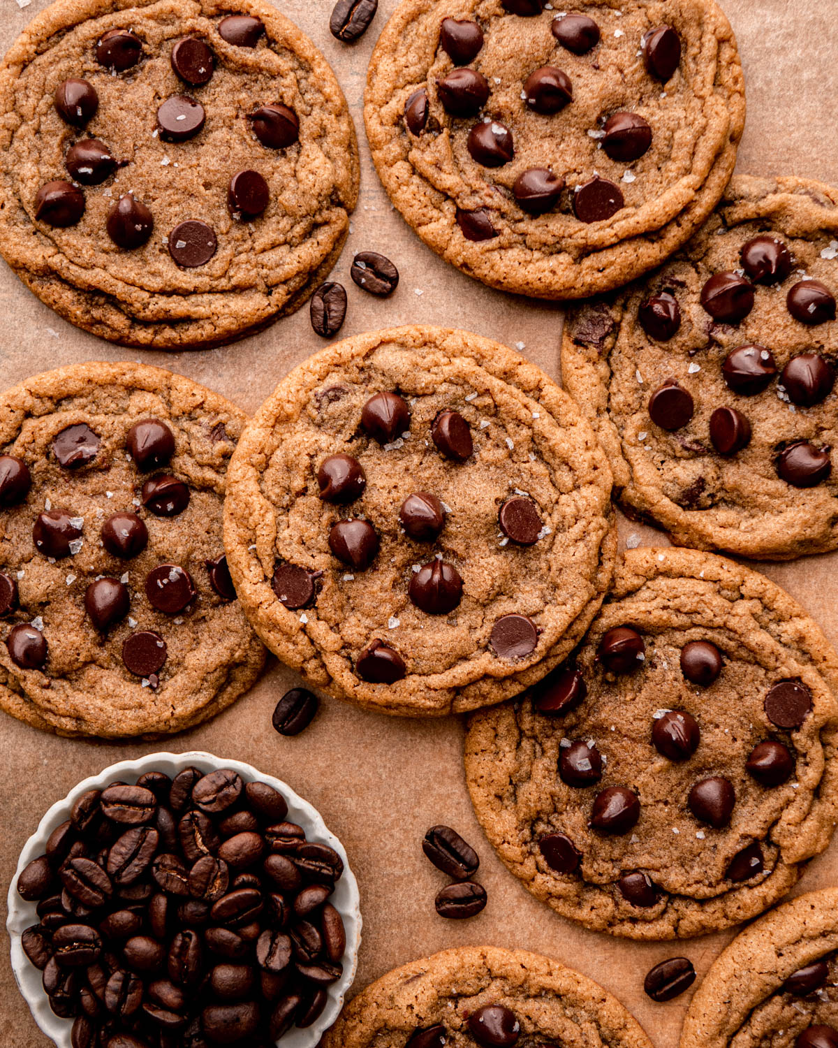 coffee cookies arranged together on parchment paper with coffee beans 