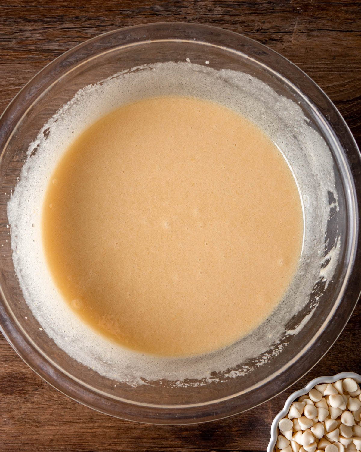 white chocolate and butter mixed into egg mixture in a glass bowm
