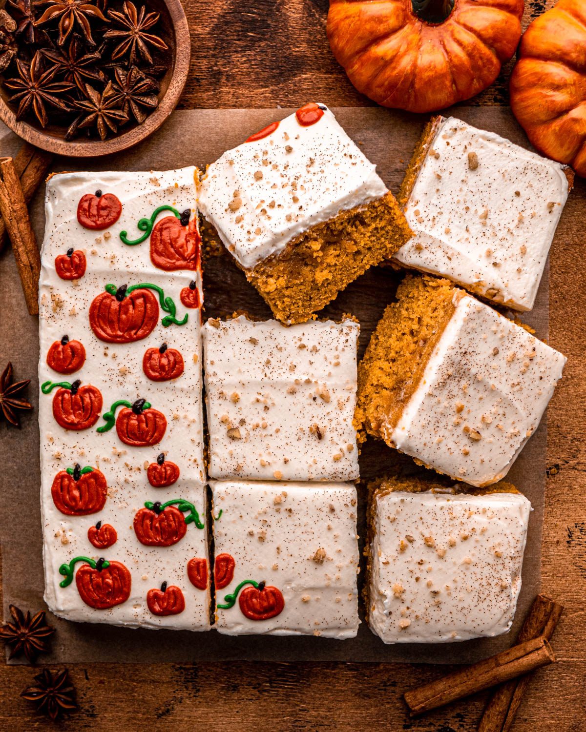 pumpkin poke cake cut into slices, decorated with little pumpkins