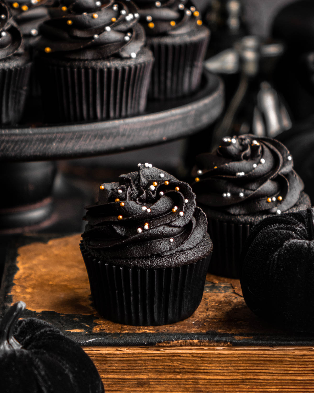 close up of a black velvet cupcake on an old book