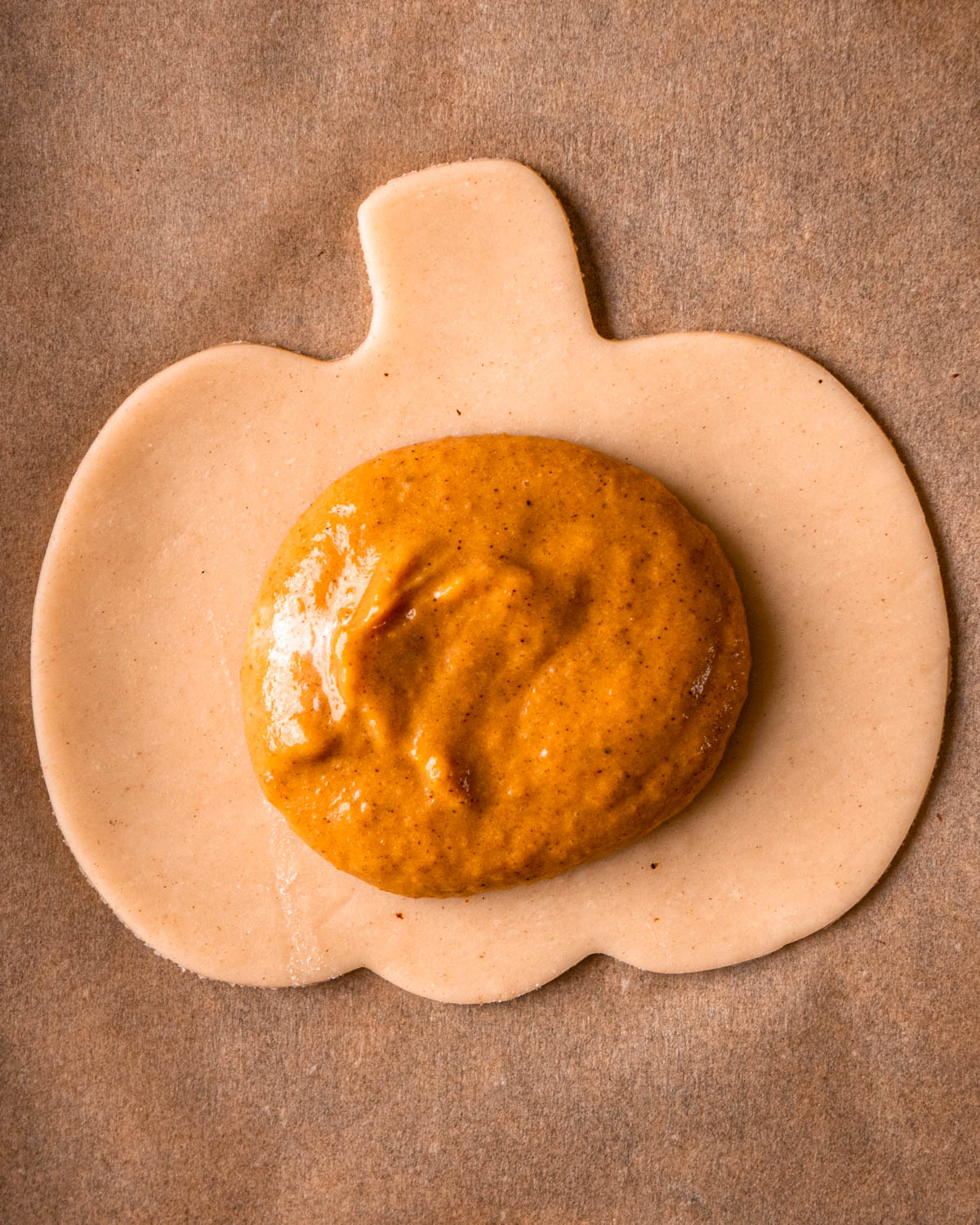 pumpkin shaped pie dough with pumpkin pie filling in the center