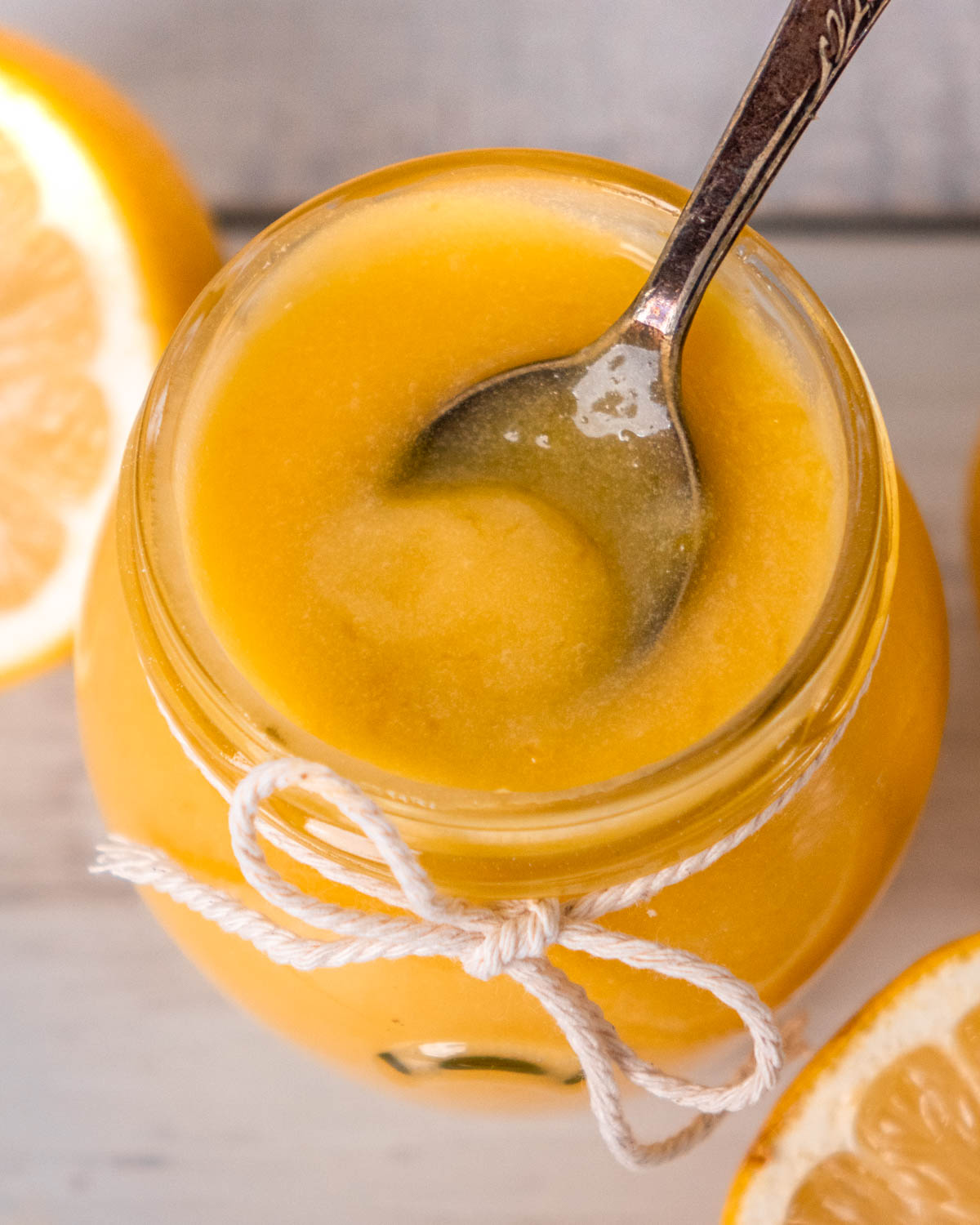 lemon curd in a jar with a spoon