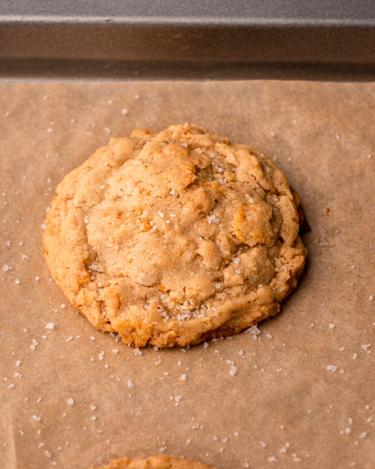 cornflake cookie on baking sheet after baking