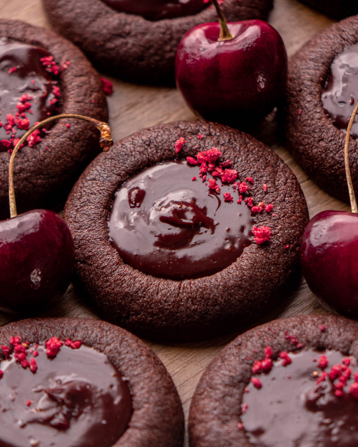 chocolate cherry cookie with other cookies and cherries around