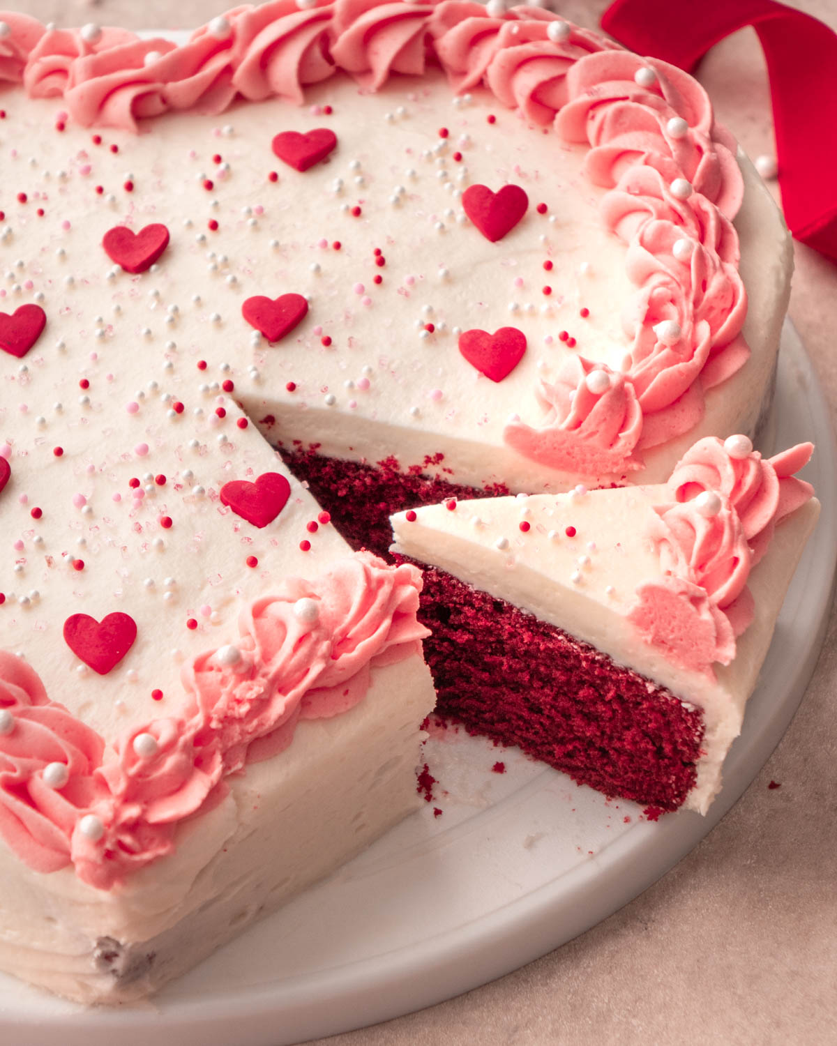 heart shaped cake with a slice cut out 
