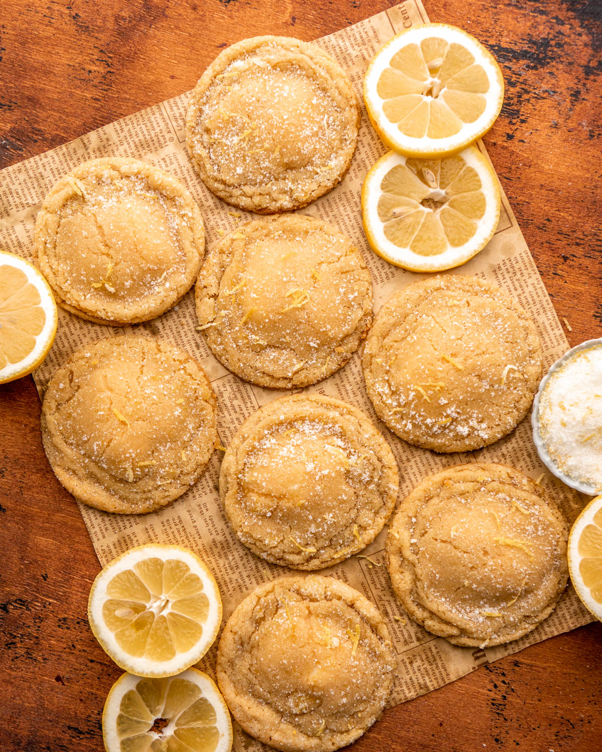 lemon cheesecake cookies on paper with lemon slices