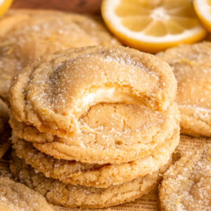 stack of lemon cheesecake cookies, top cookie with bite taken out