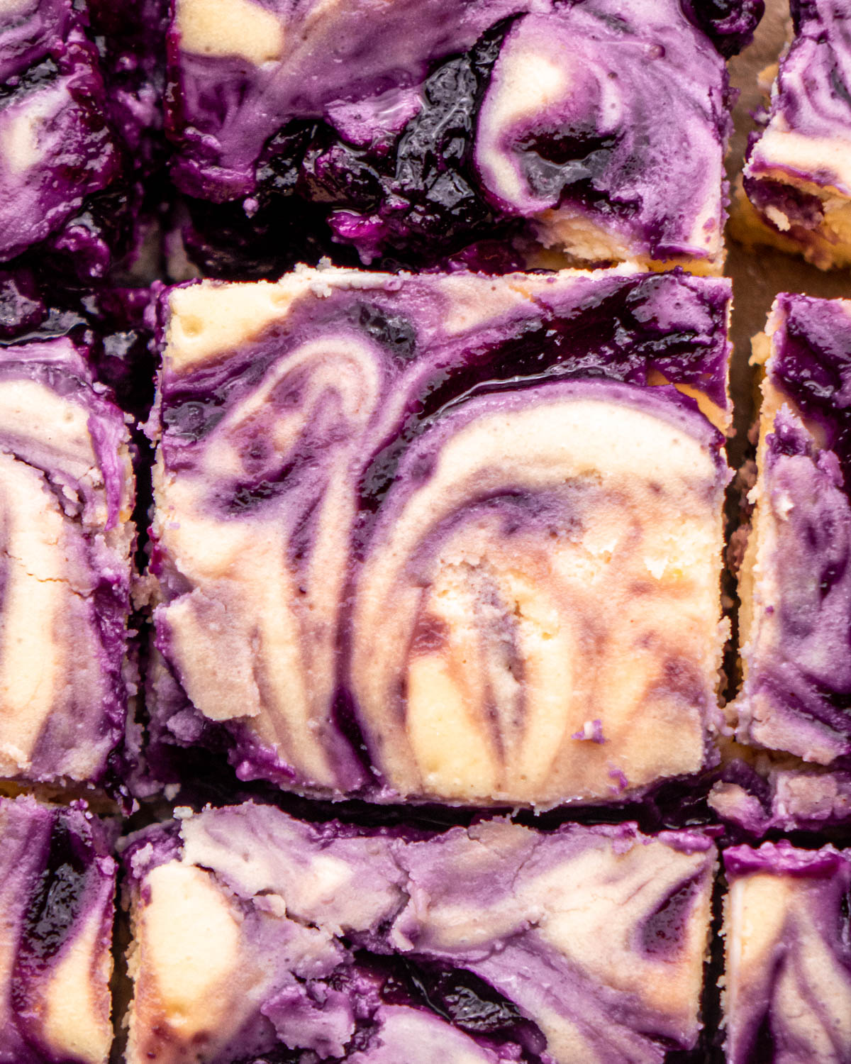 close up of blueberry cheesecake bar with other bars around