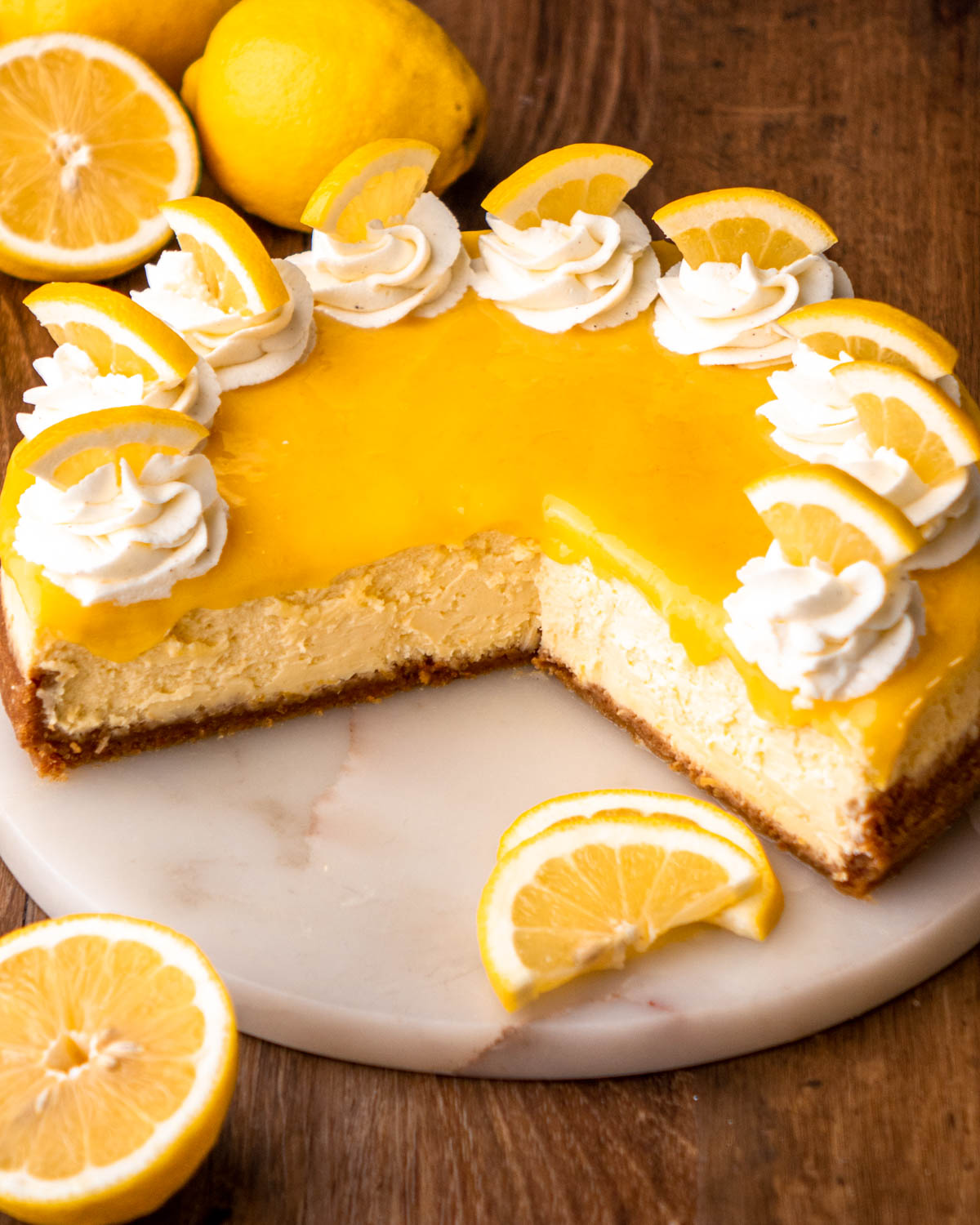 lemon cheesecake sliced open on a marble tray