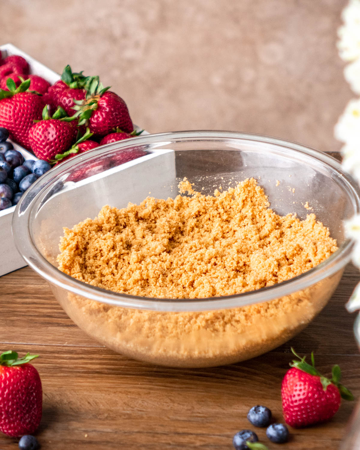 graham cracker crumbs, melted butter and sugar mixed together in a glass bowl